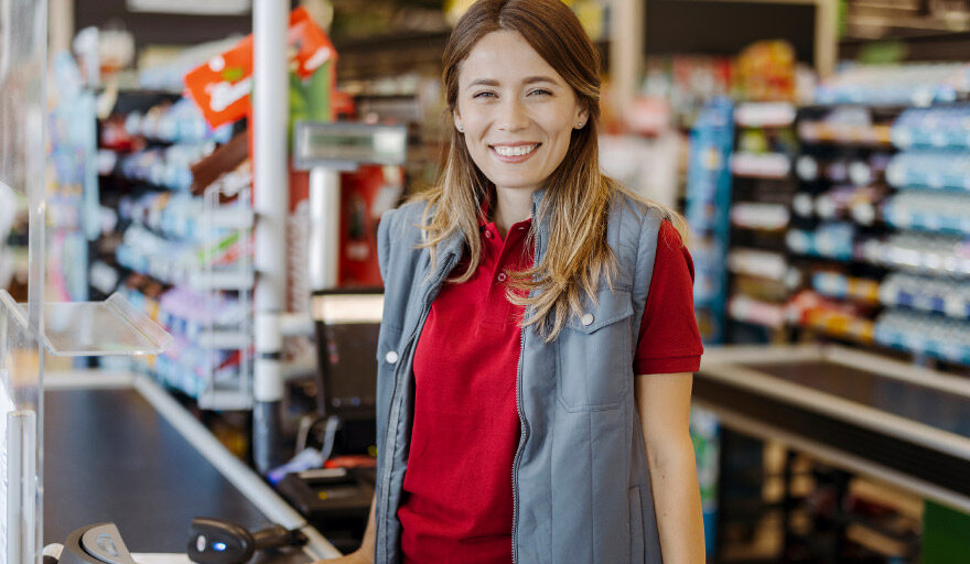 Smiling woman working as a cashier.