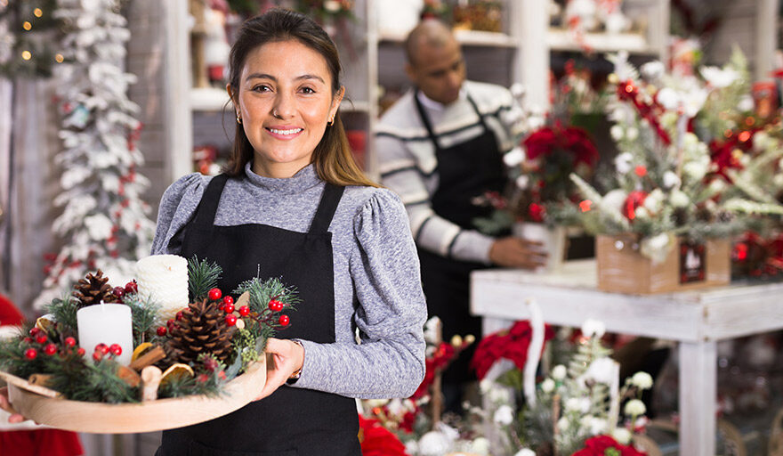 Woman working in a retail store during Christmas time.