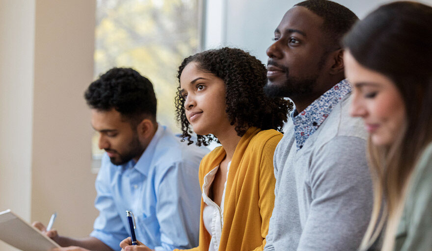 Group of employees taking notes at a training.