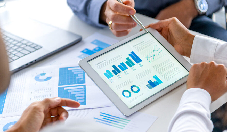 Professionals looking at charts and graphs on a tablet