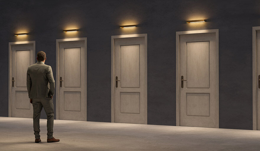 Man standing in front of several closed doors